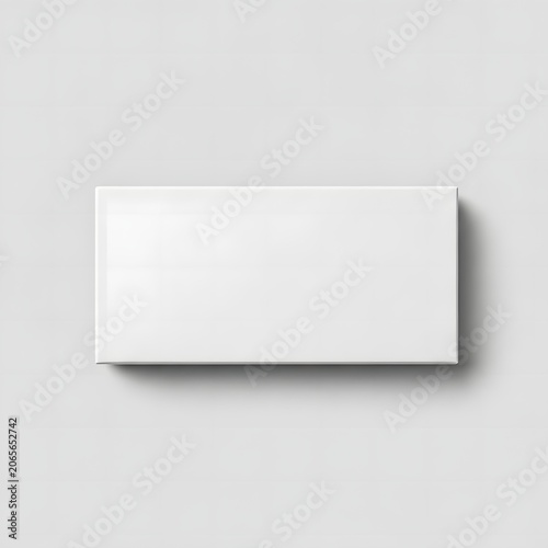 Top view of a blank white rectangular medical device box on a gray background. Flat lay perspective of a pharmaceutical or healthcare product packaging mockup for design presentation.