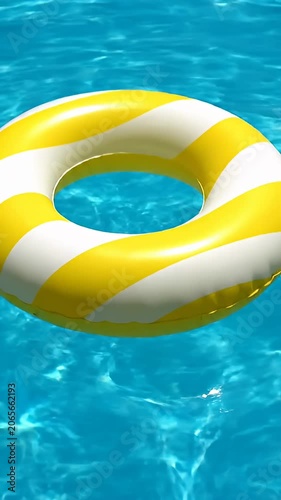 Yellow and white striped inflatable swim ring in pool.