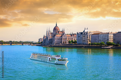 Hungarian Parliament Building at sunset with cruise ship on the Danube river, Budapest, Hungary