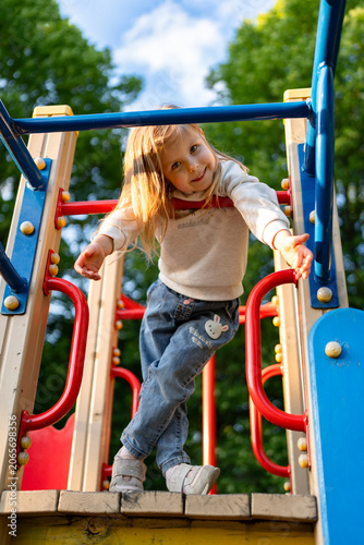 Принти на полотні Cute beautiful smiling little girl on the playground for fun, games or recreation