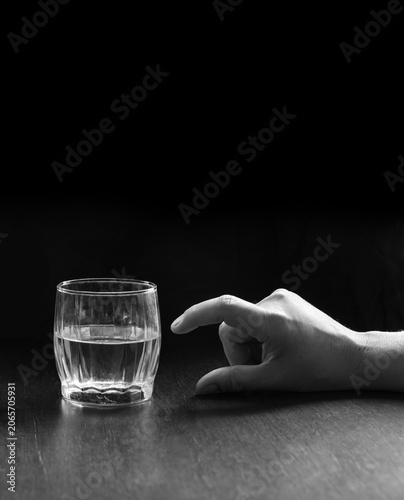 фотографія An optimist and a pessimist's opinion about a glass of water