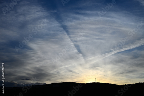 Photography Dramatic Sunset Sky with Wispy Clouds and Radio Tower Silhouette on Forested Hil