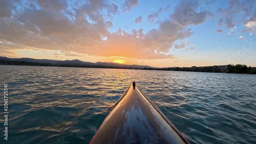 Immersive POV from a kayak - paddling on Boedecker Reservoir in Loveland, Colorado, with sunset over Rocky Mountains