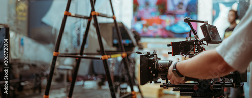 Professional cinema and video camera on the set. Shooting shift, lighting fixtures, shooting equipment and the team.