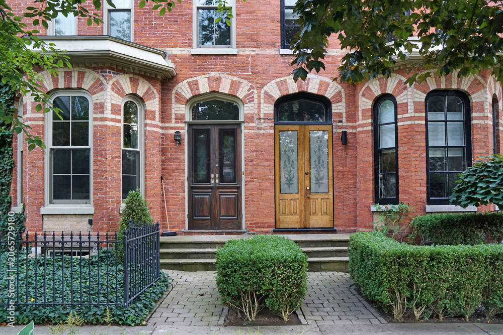 Naklejka premium Victorian townhouses with polychromatic brick design, common in downtown Toronto