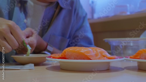 Hands Using Chopsticks to Pick Up Japanese Food. Close-Up of Authentic Asian Dining Experience
