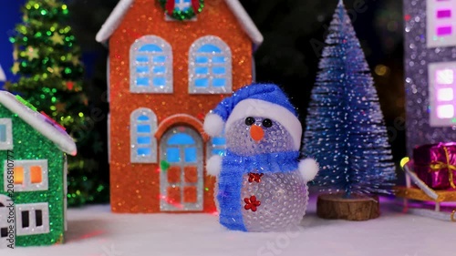 In Christmas Town, among the colorful houses, there is a yellow car with Christmas trees and snowmen