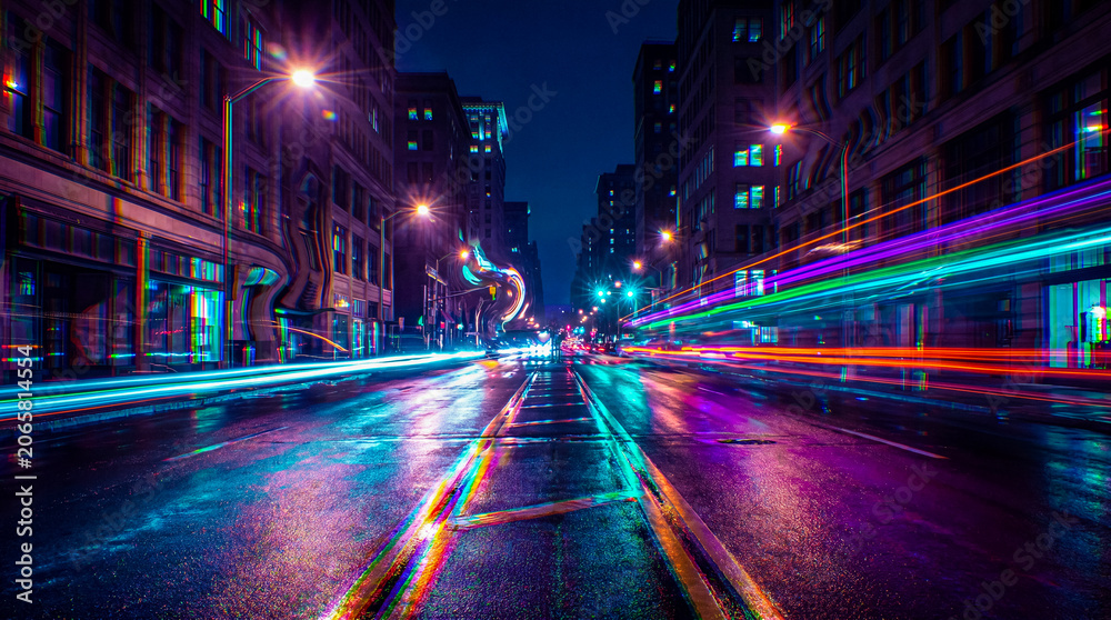 Obraz premium City street at night with light trails and wet reflections
