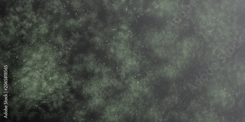 Abstract dark textured background with green scattered speckled particles creating an organic grunge surface. Gradient transitions from dense, dark detail on the left to green tones
