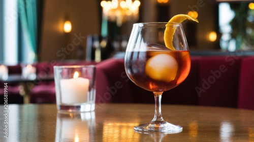 Elegant Red Wine Glass With Lemon Twist on Rustic Wooden Table in Warm Lighting