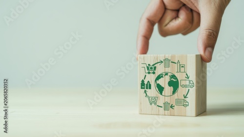 Hand holding eco-friendly paper cutout of global sustainability and green energy