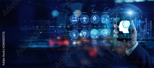 Photos Data strategist holding a mobile phone analyzing global Business Intelligence data on a holographic world map