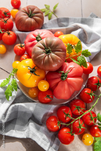 Tableau sur toile Fresh heirloom tomatoes and cherry tomatoes on tile surface