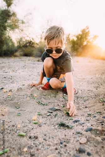 Boy in desert landscape with sunglasses