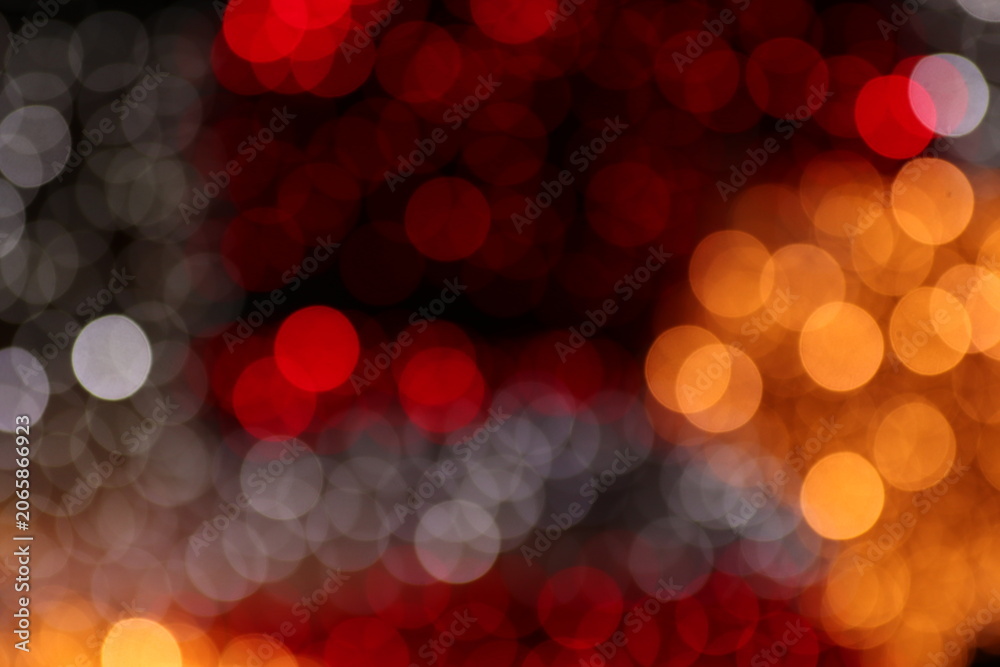 Fototapeta premium Three distinct color zones cool silver left, deep red center and warm orange right divide dark bokeh frame. Black gaps between orbs add depth and drama, ideal for nightlife or premium dark UI overlays