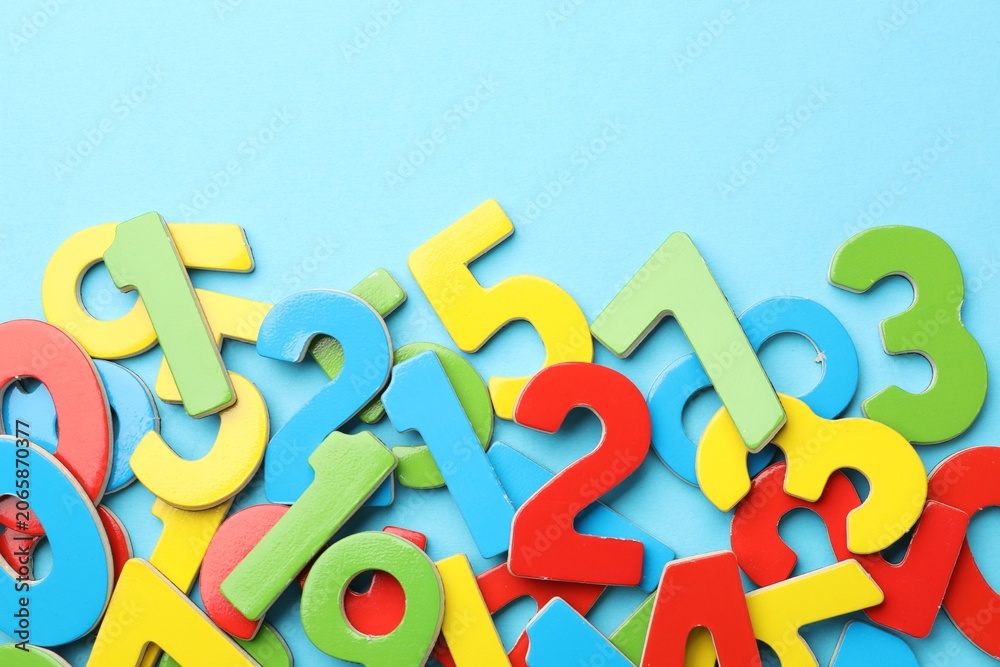 Fototapeta premium Colorful numbers on light blue background, flat lay. Space for text