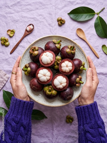 Fresh Mangosteens on Purple Background