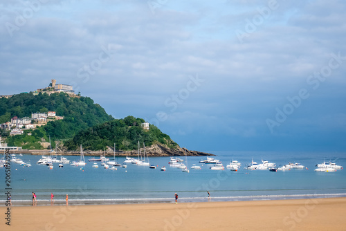 Sunny coastal beach scene with boats