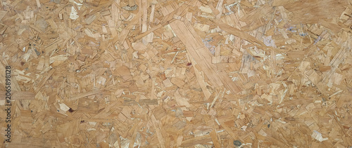 Wooden background. OSB boards made of brown wood chips sanded into wooden background, Wood plank texture background, surface texture of oriented board OSB. not ai