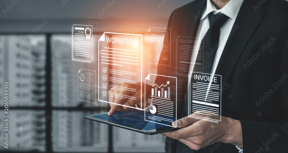 Obraz premium Businessman Using Tablet to Manage Documents and Graphs for Workflow Optimization in Modern Office Environment. Bitwise.
