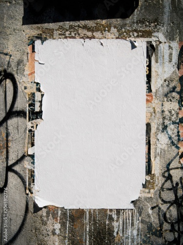 Distressed blank paper poster mockup on weathered concrete wall with torn layered edges graffiti details urban decay texture and authentic street advertising aesthetic