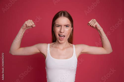 Confident woman showing strong arms