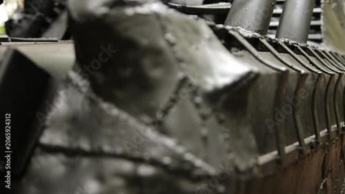 Combat ready, wooded background, war machine. Detailed view showing armored, battle-ready car with spikes, parked in forested area.