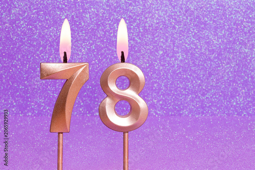 Number 78 on a pink background with blurred bright dots - Birthday or anniversary card with abstract blurred dots that glow