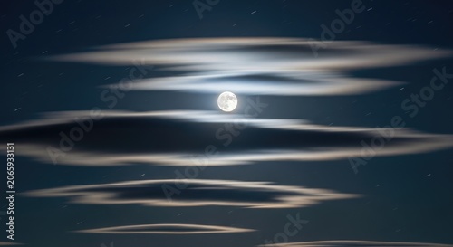 Nighttime Moon Illuminates the Clouds in the Dark Sky Above.