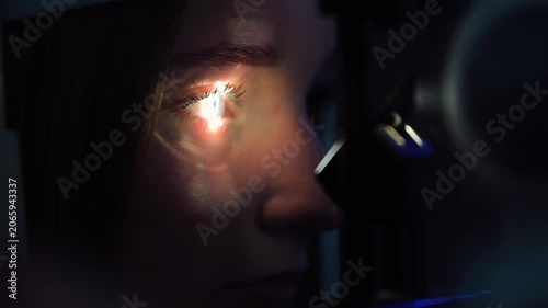 Eye examination with a machine at an optometrist's office in a city during daylight