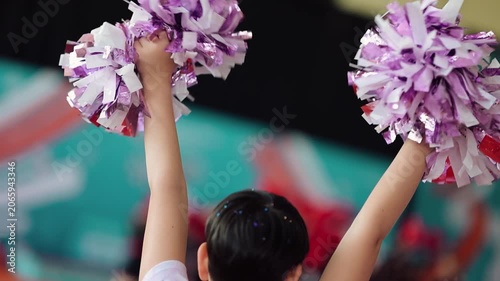 Cheerleading practice at the gym with pom poms in a lively setting