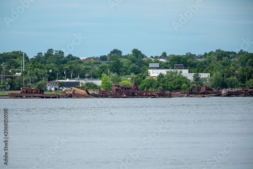 Abandoned vessels line the shoreline of the Staten Island Boat Graveyard along the Arthur Kill waterway in New York.