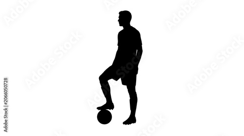 Silhouette of man playing soccer ball