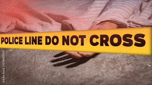 Crime scene concept with a dead body lying on the ground covered by a cloth, behind a yellow tape with the text POLICE LINE DO NOT CROSS.