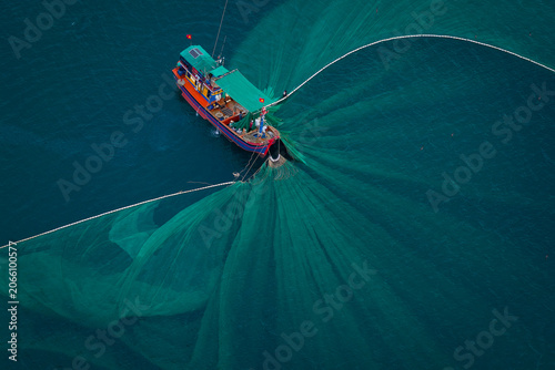 Obraz na plátně Aerial view of fishing boats using purse seine nets to catch anchovies in the coastal waters of Tuy An, Phu Yen, Vietnam
