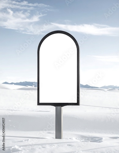 A blank, arched sign in a snowy landscape with a blue sky
