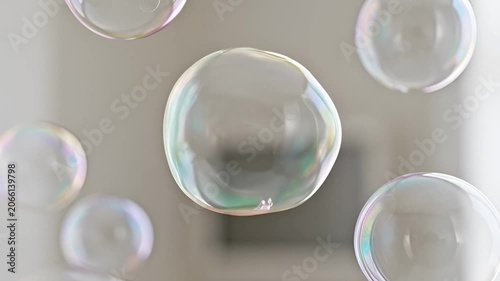 Abstract close up of bubbles floating on a light grey surface