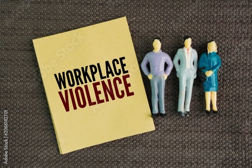Fotografi Miniature people and paper with the word Workplace violence
