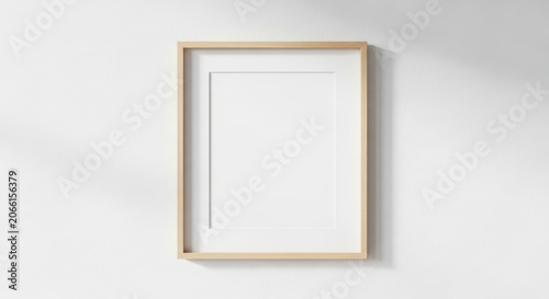 Minimalist vertical wooden picture frame mockup on a white wall