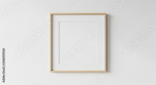 Minimalist empty picture frame hanging on a clean white wall background