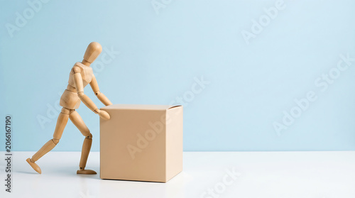 Employee performance evaluation and productivity concept showing a wooden mannequin pushing a cardboard box with copy space for a mid-year performance review presentation.