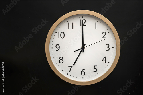 wall clock showing 7 o'clock. 19:00