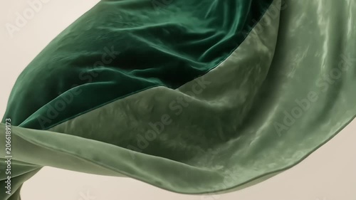  Elegant folds of green velvet fabric waving and draping gracefully in slow motion