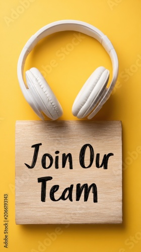 Stylish flat lay featuring headphones and a laptop alongside a recruitment sign for effective talent acquisition strategies