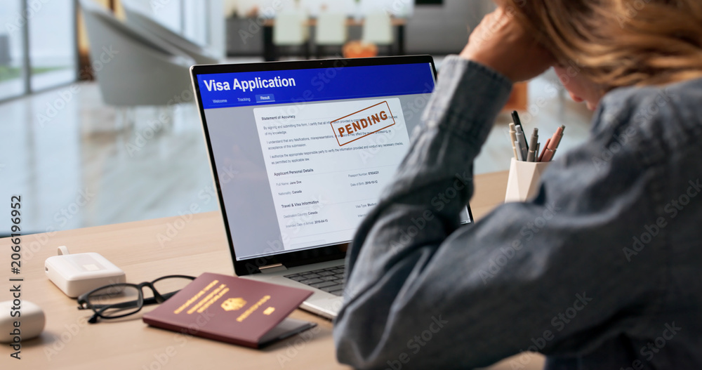 Fototapeta premium Woman Anxiously Checking Real-time Visa Application Status