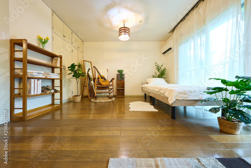 Bright studio apartment with bed sofa and dining table interior