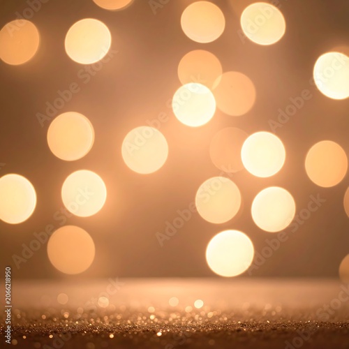 A blurry background with numerous round, glowing golden lights and a sparkly surface