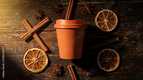 Warm Beverage in a Cup with Cinnamon Sticks and Dried Orange Slices on a Wooden Table.