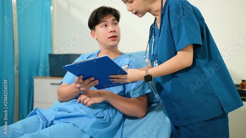 atient reviewing and signing medical consent documents with healthcare staff during hospital registration, consultation, treatment preparation