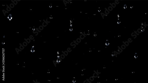 Fotografía Close-up view of numerous clear water droplets falling against a solid black background